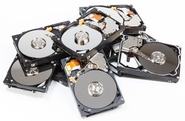 A pile of hard drives with open covers on white background