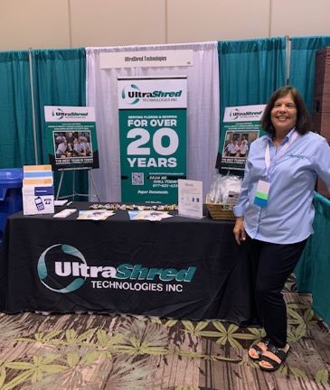 Margaret Meier stands in the UltraShred booth at a trade show